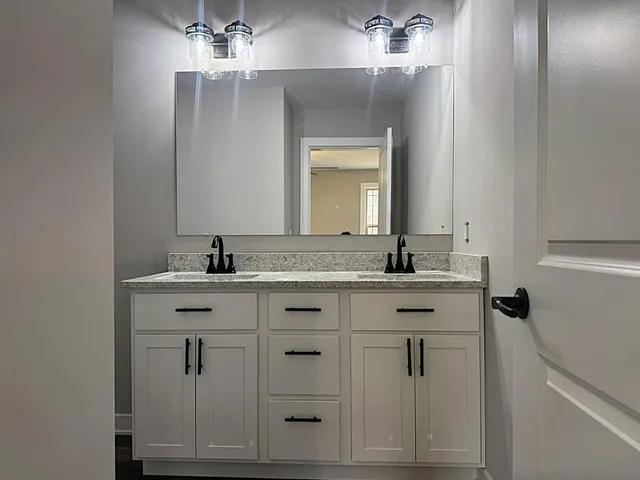 a bathroom with a toilet a sink a mirror and bathtub