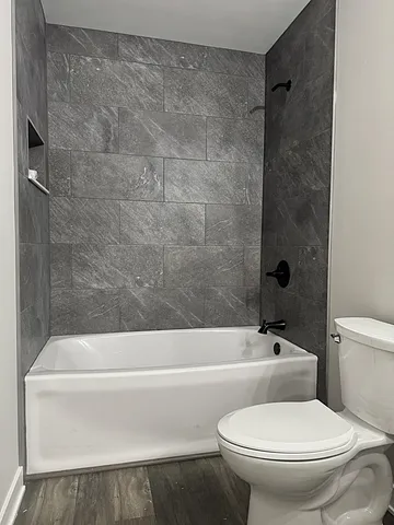 an empty room with closet and a chandelier fan