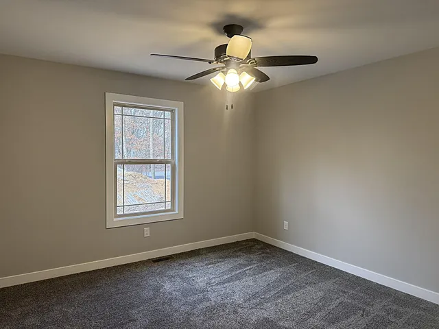 a bathroom with a toilet sink and a mirror