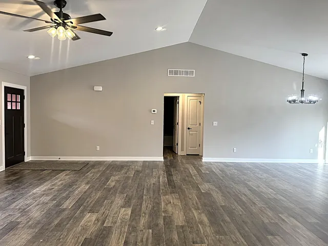 a view of kitchen with granite countertop cabinets and wooden floor