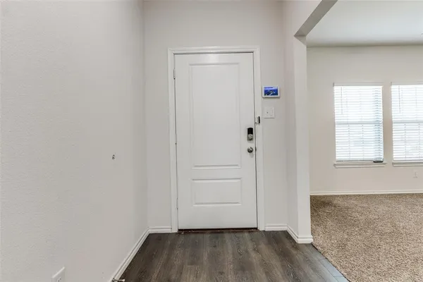 a view of front door with wooden floor