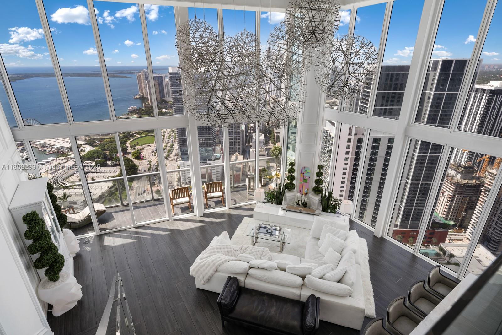 888 Biscayne Boulevard, Unit 5701 Miami, FL 33132 - Photo 12 of 35 a living room with furniture and a floor to ceiling window
