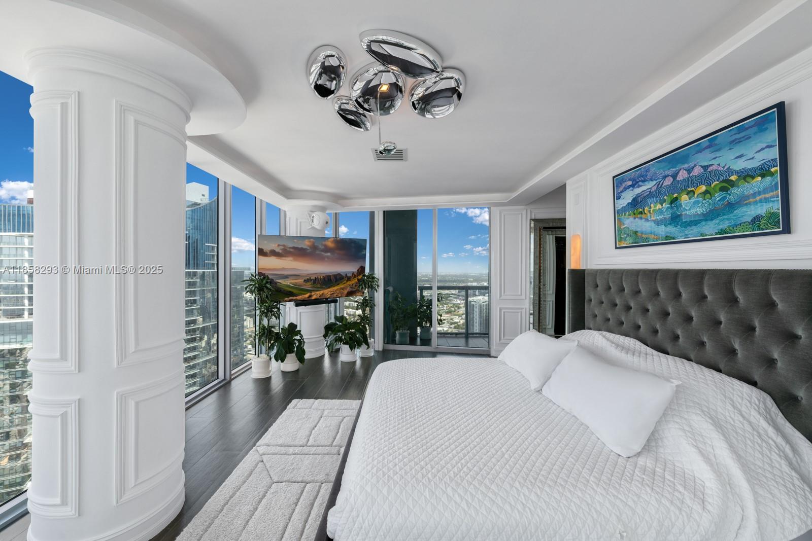 888 Biscayne Boulevard, Unit 5701 Miami, FL 33132 - Photo 17 of 35 a bedroom with a large bed and a painting on the wall