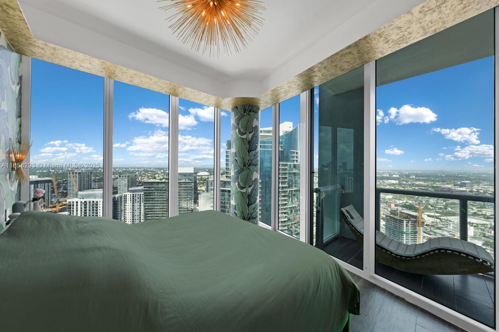 888 Biscayne Boulevard, Unit 5701 Miami, FL 33132 - Photo 22 of 35 a bedroom with a large bed and a balcony view
