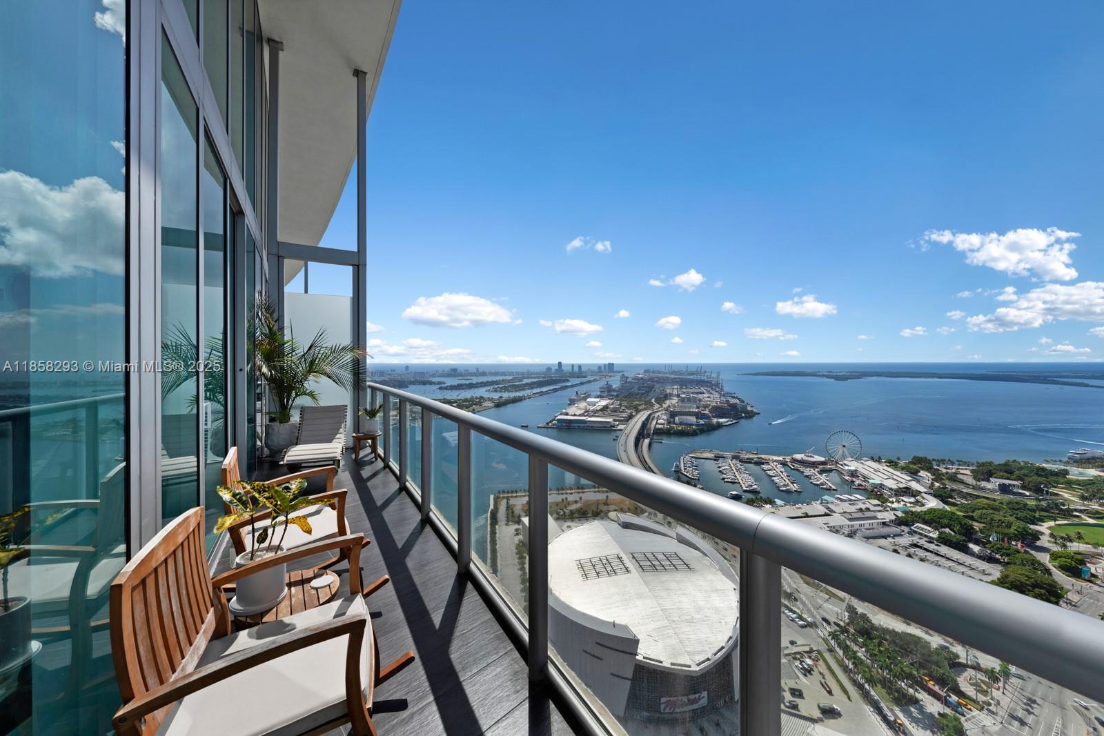 888 Biscayne Boulevard, Unit 5701 Miami, FL 33132 - Photo 24 of 35 a view of a balcony with wooden floor and fence