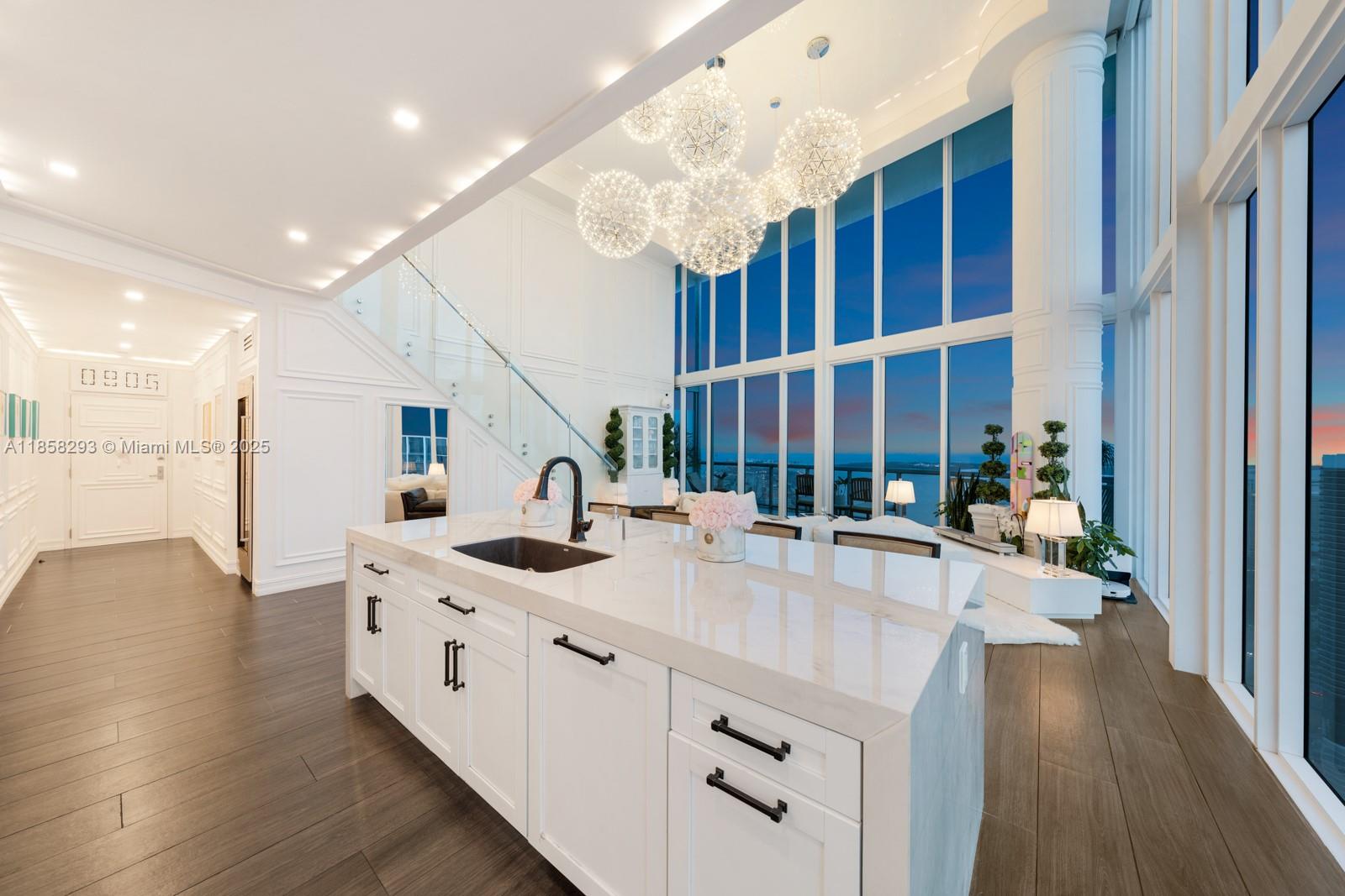 888 Biscayne Boulevard, Unit 5701 Miami, FL 33132 - Photo 30 of 35 a kitchen with stainless steel appliances kitchen island granite countertop a sink and cabinets