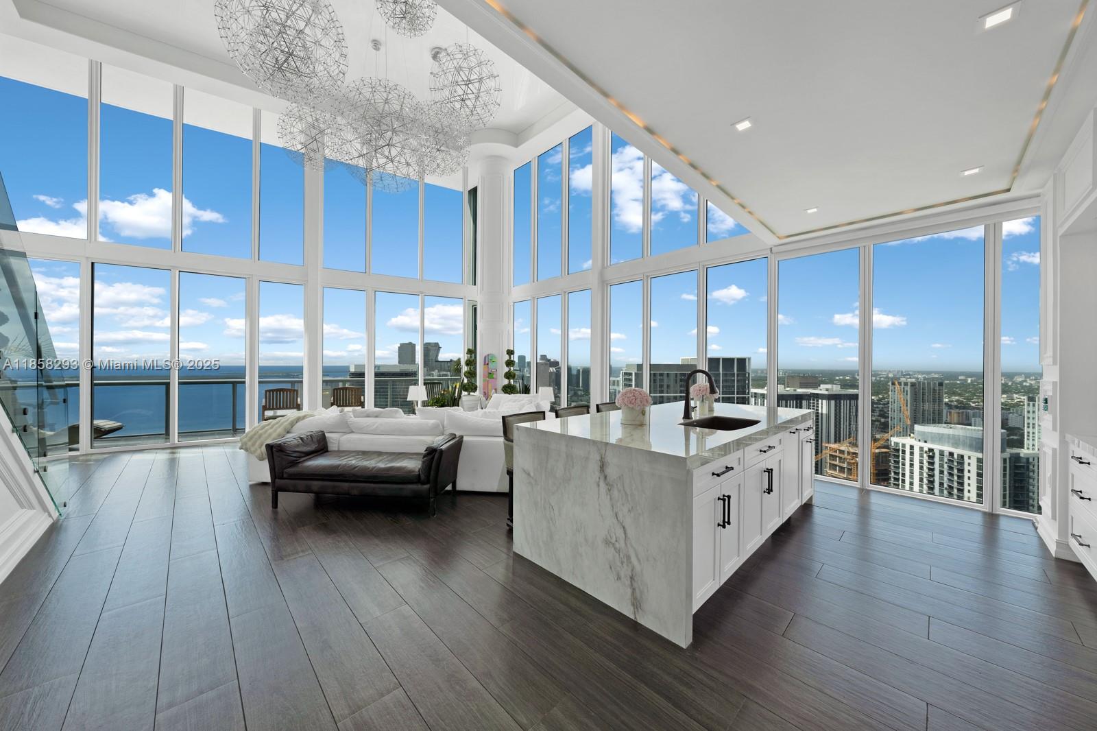 888 Biscayne Boulevard, Unit 5701 Miami, FL 33132 - Photo 3 of 35 a kitchen with stainless steel appliances a lot of counter space and wooden floors