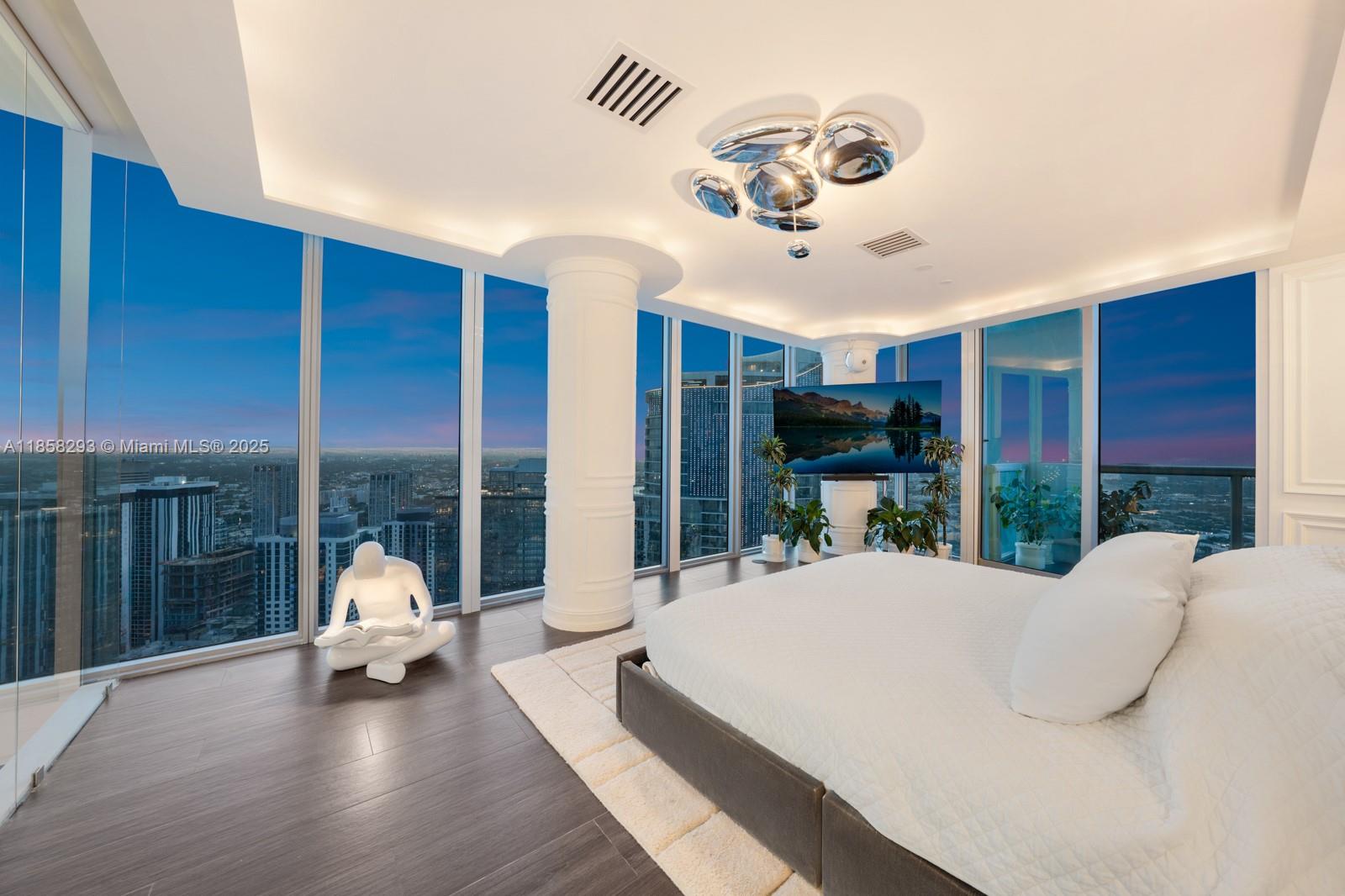 888 Biscayne Boulevard, Unit 5701 Miami, FL 33132 - Photo 31 of 35 a bed room with a bed and a large window