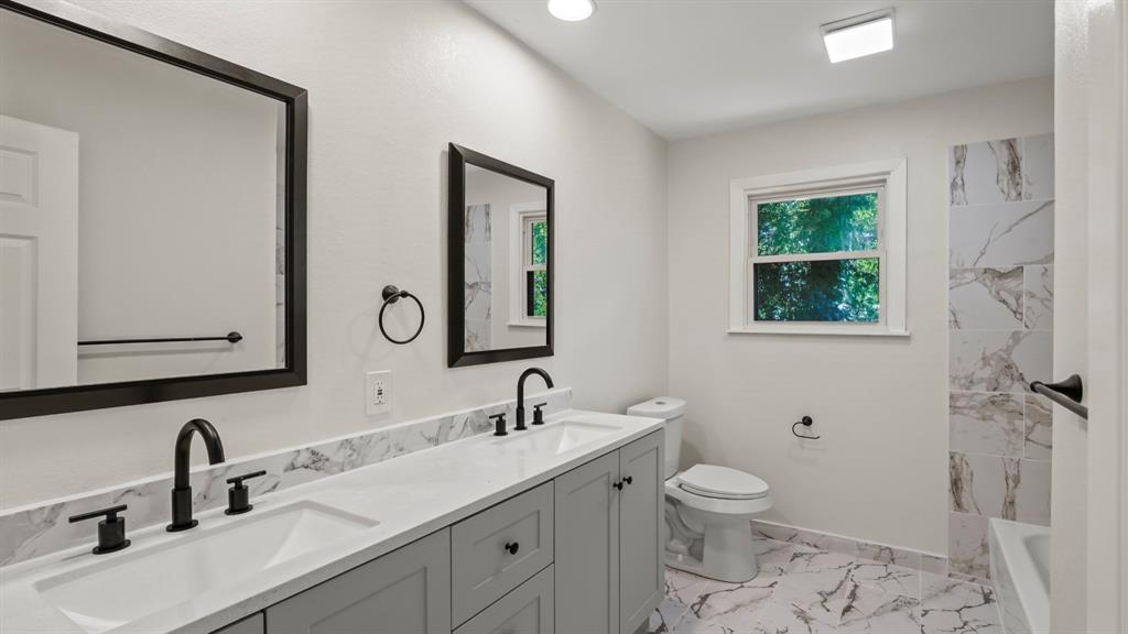 4600 Robinwood Drive Waco, TX 76708 - Photo 9 of 24 a bathroom with a double vanity sink toilet and a mirror