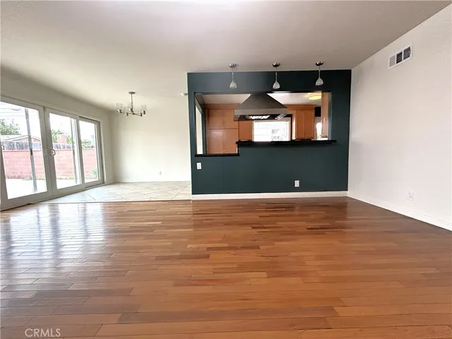 a view of a room with wooden floor