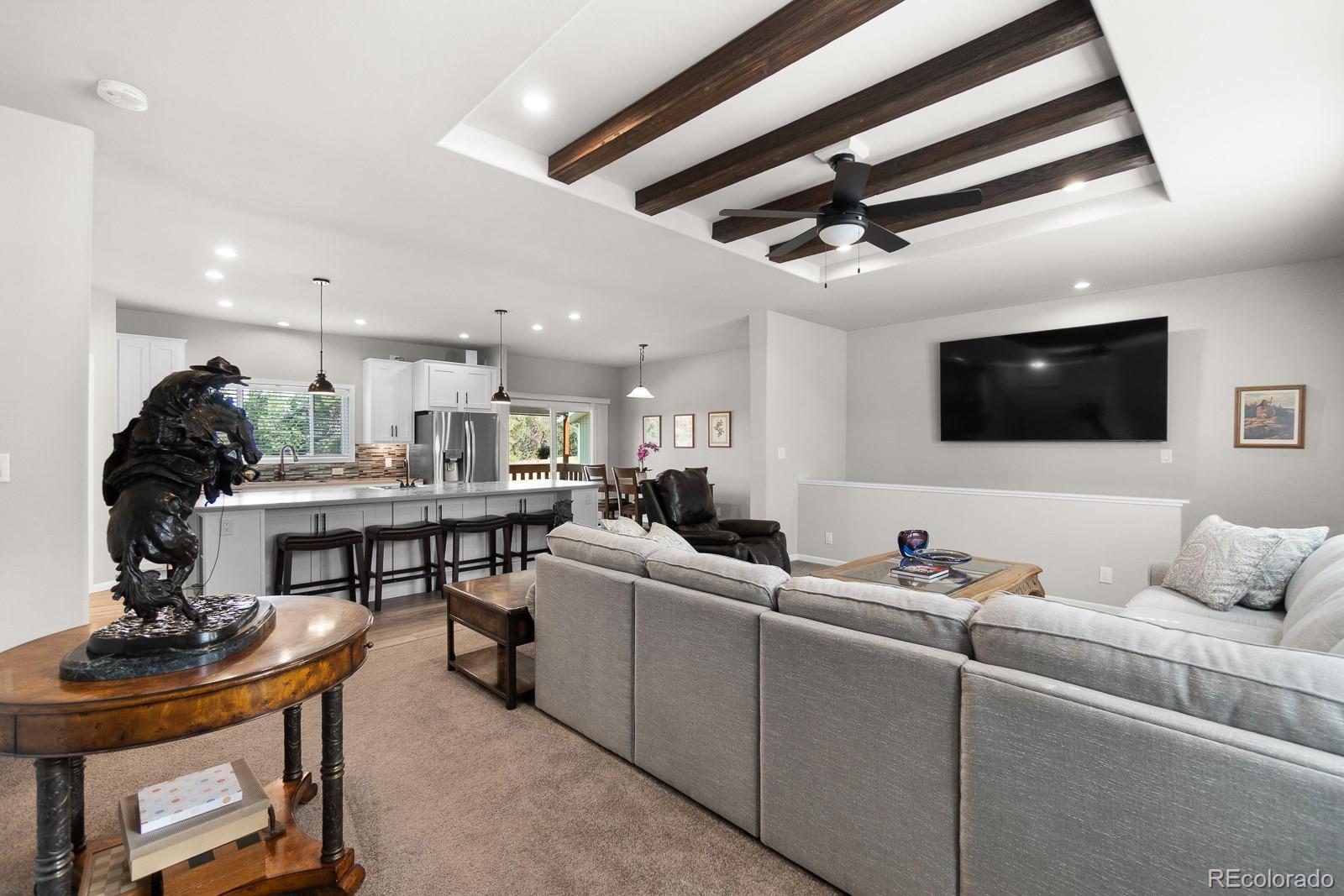11374 Ridgewood Way Kiowa, CO 80117 - Photo 12 of 49 a living room with furniture and a flat screen tv