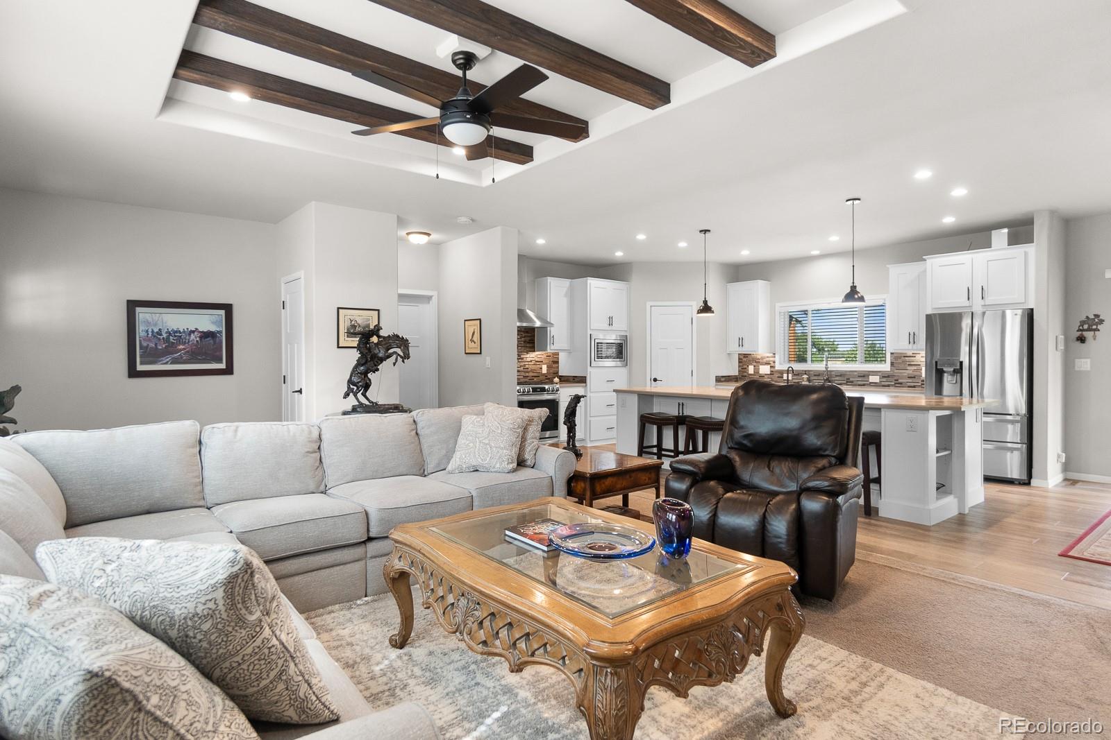 11374 Ridgewood Way Kiowa, CO 80117 - Photo 13 of 49 a living room with furniture kitchen view and a chandelier