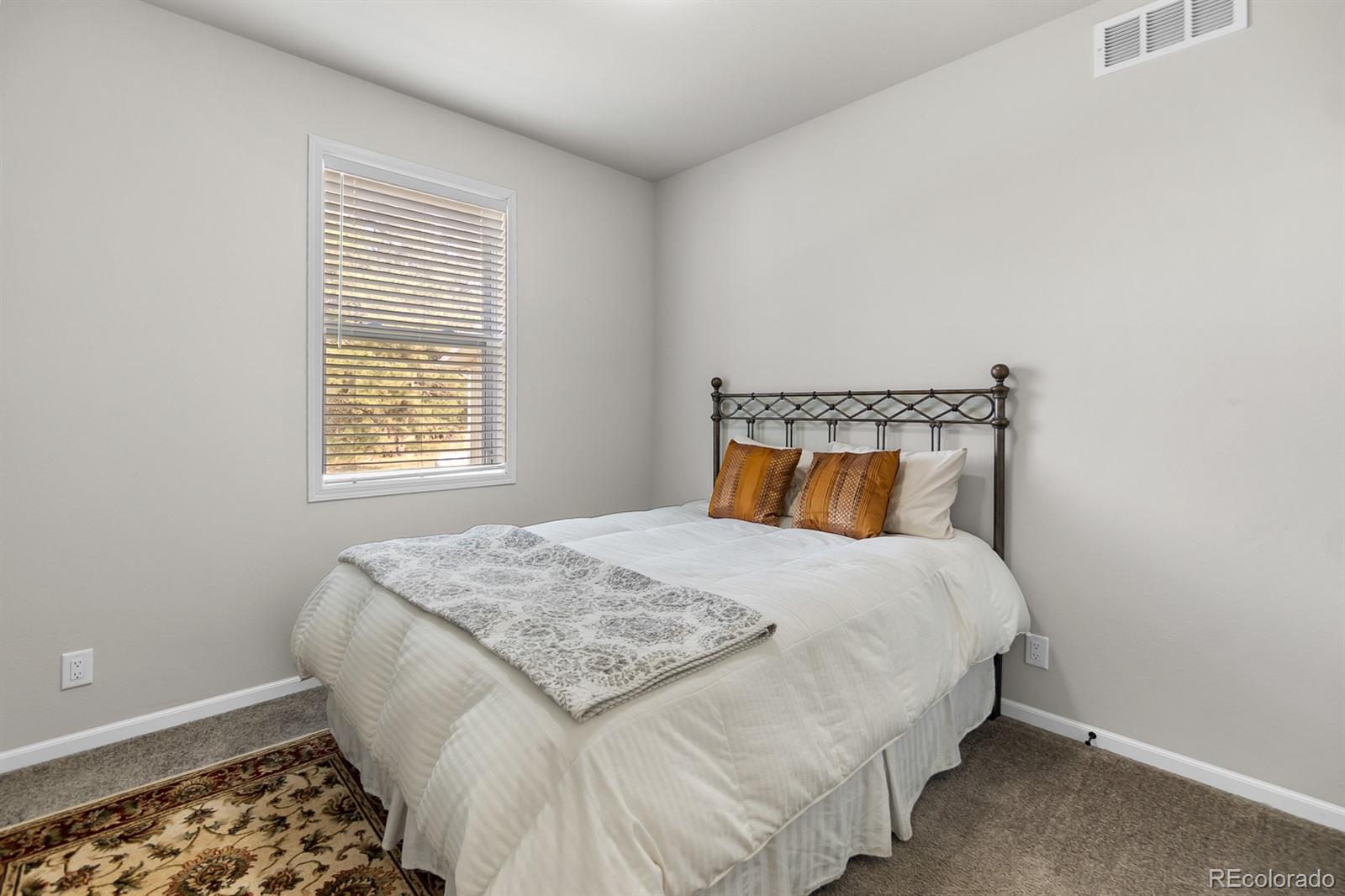 11374 Ridgewood Way Kiowa, CO 80117 - Photo 20 of 49 a bedroom with a bed and a window
