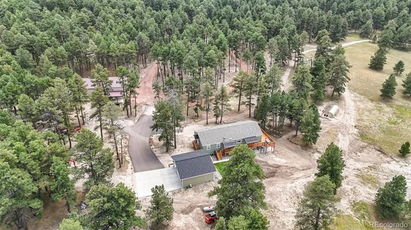 an aerial view of a house with outdoor space and street view