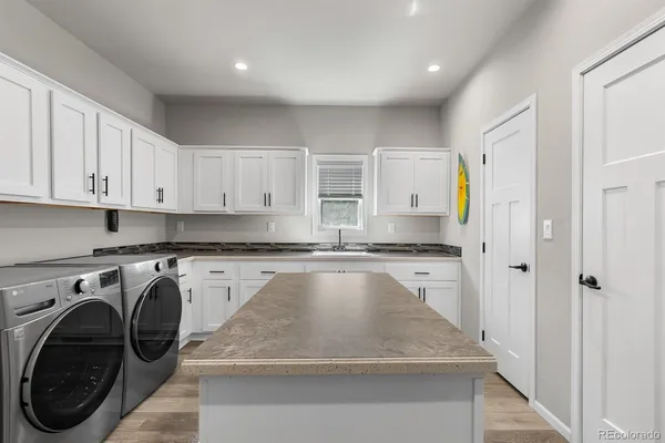 a kitchen with a sink a stove and cabinets