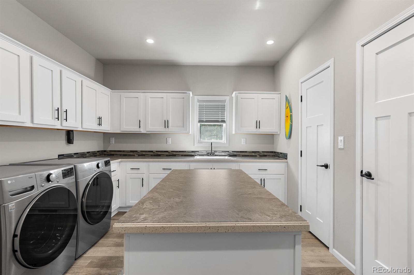 11374 Ridgewood Way Kiowa, CO 80117 - Photo 22 of 49 a kitchen with a sink a stove and cabinets