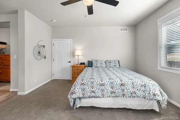 a bedroom with a bed and window