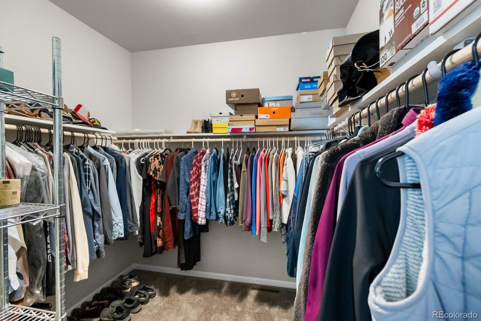 11374 Ridgewood Way Kiowa, CO 80117 - Photo 28 of 49 a view of walk in closet with clothes