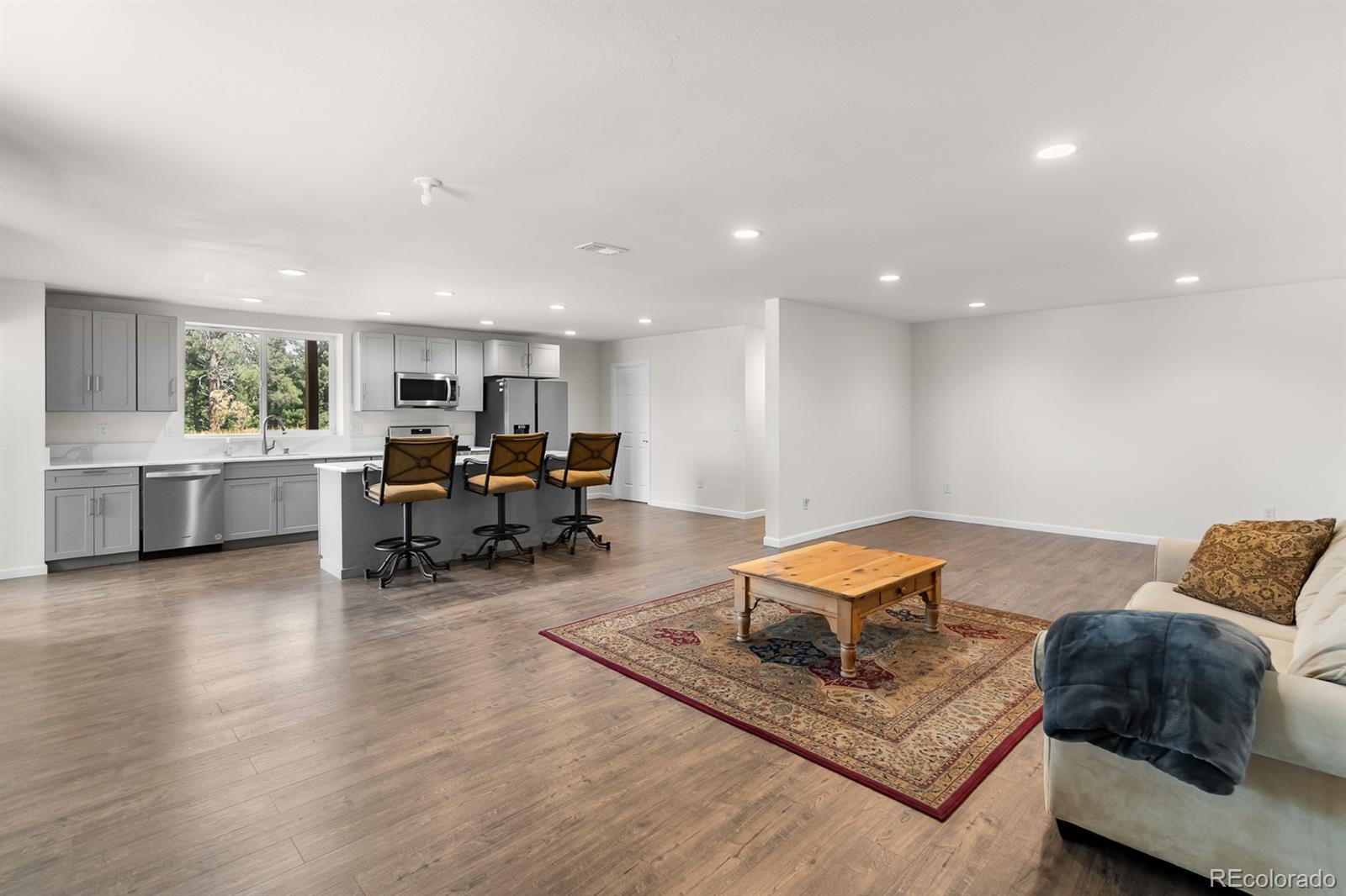 11374 Ridgewood Way Kiowa, CO 80117 - Photo 29 of 49 a living room with furniture and a wooden floor