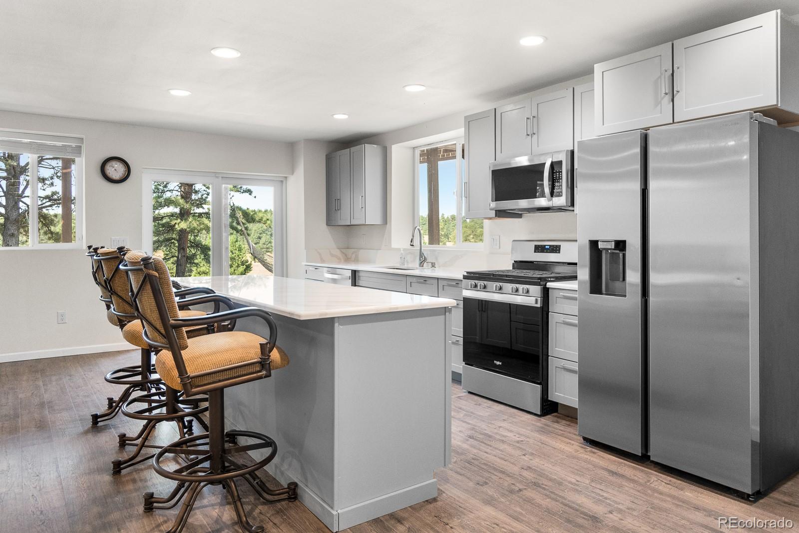 11374 Ridgewood Way Kiowa, CO 80117 - Photo 31 of 49 a kitchen with kitchen island a counter top space a sink stainless steel appliances and cabinets