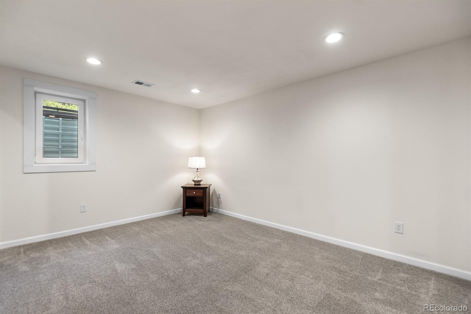 11374 Ridgewood Way Kiowa, CO 80117 - Photo 34 of 49 an empty room with chandelier and window