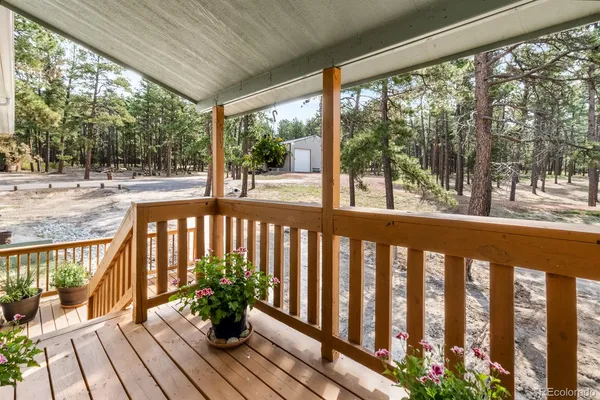 a view of a balcony with wooden floor