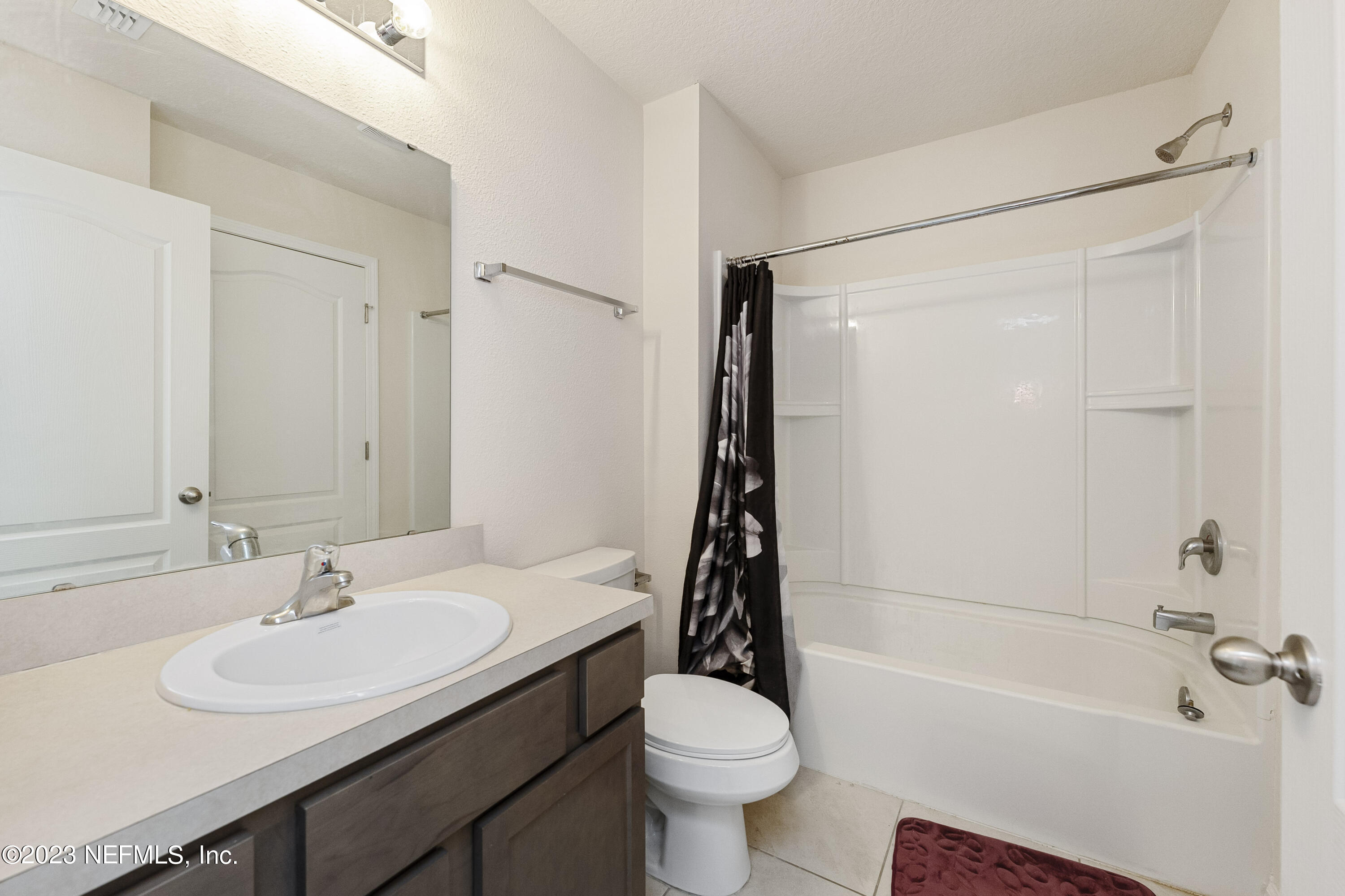954 Rotary Road Jacksonville, FL 32211 - Photo 13 of 18 a bathroom with a sink a toilet and a bathtub