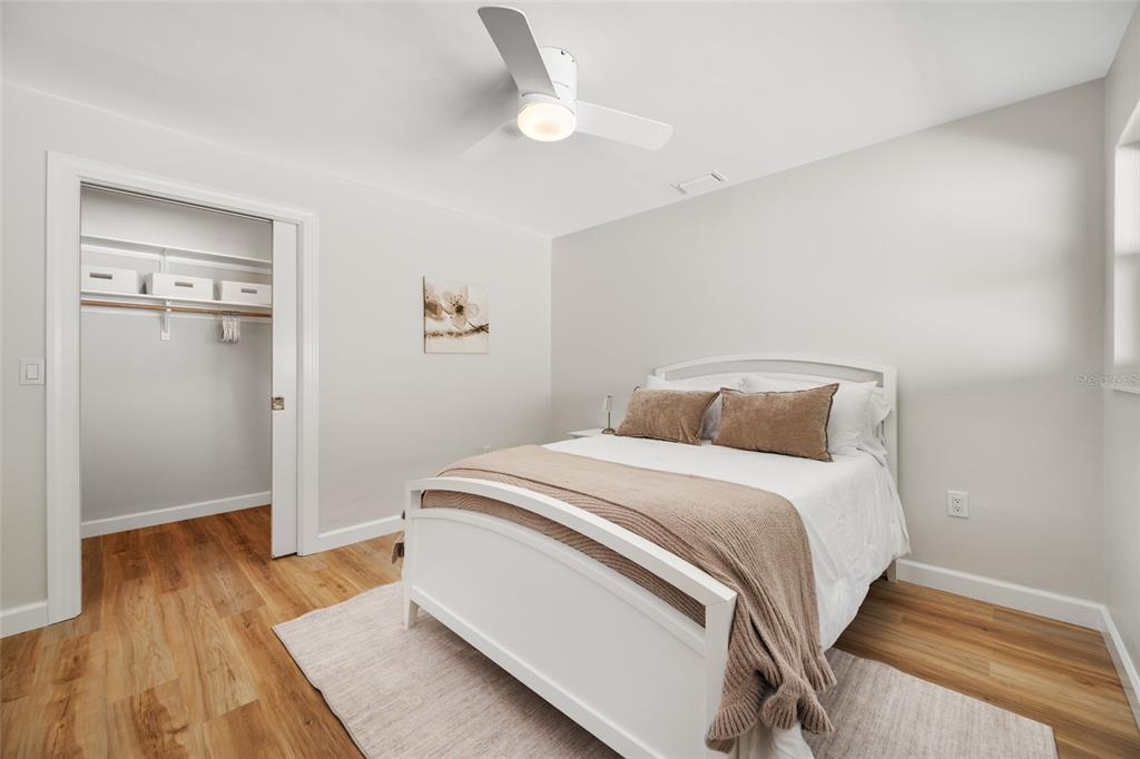 656 Mehlenbacher Road Belleair, FL 33756 - Photo 32 of 49 a bedroom with a bed and wooden floor