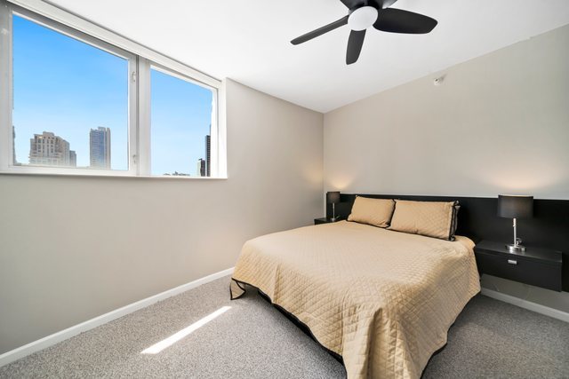 600 North Dearborn Street, Unit 1102 Chicago, IL 60654 - Photo 13 of 26 a bedroom with a bed and window