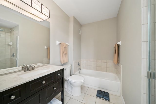 600 North Dearborn Street, Unit 1102 Chicago, IL 60654 - Photo 17 of 26 a bathroom with a bathtub shower sink vanity and toilet
