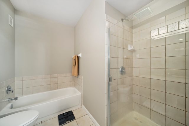 600 North Dearborn Street, Unit 1102 Chicago, IL 60654 - Photo 18 of 26 a bathroom with a bathtub shower sink and toilet