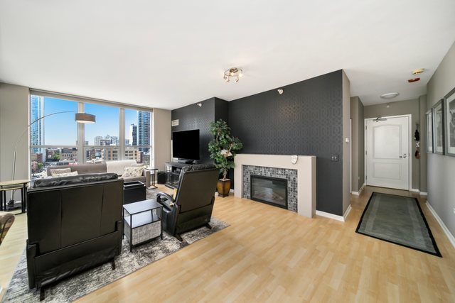 600 North Dearborn Street, Unit 1102 Chicago, IL 60654 - Photo 4 of 26 a living room with furniture a fireplace and a flat screen tv