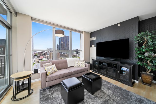 600 North Dearborn Street, Unit 1102 Chicago, IL 60654 - Photo 6 of 26 a living room with furniture and a flat screen tv