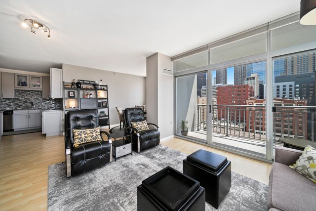 600 North Dearborn Street, Unit 1102 Chicago, IL 60654 - Photo 7 of 26 a living room with furniture and a flat screen tv