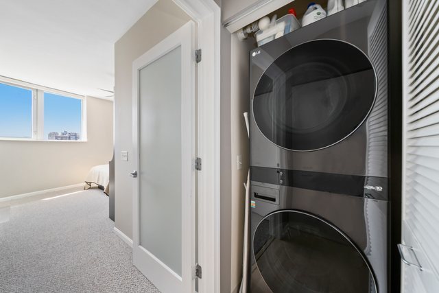 600 North Dearborn Street, Unit 1102 Chicago, IL 60654 - Photo 9 of 26 a view of a hallway with washer and dryer