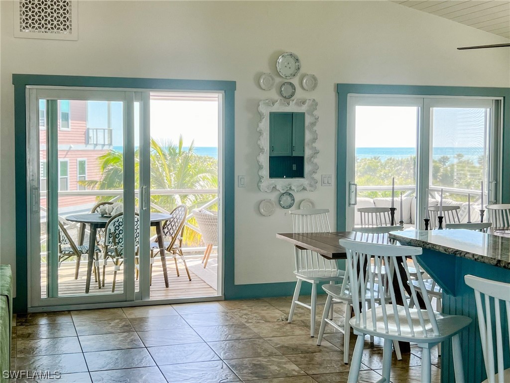 4480 Panama Shell Drive Upper Captiva, FL 33924 - Photo 13 of 50 a view of a dining room with furniture a chandelier and wooden floor