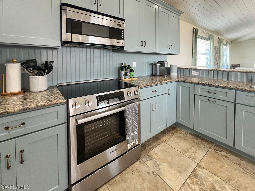 4480 Panama Shell Drive Upper Captiva, FL 33924 - Photo 26 of 50 a kitchen with granite countertop cabinets stainless steel appliances and sink
