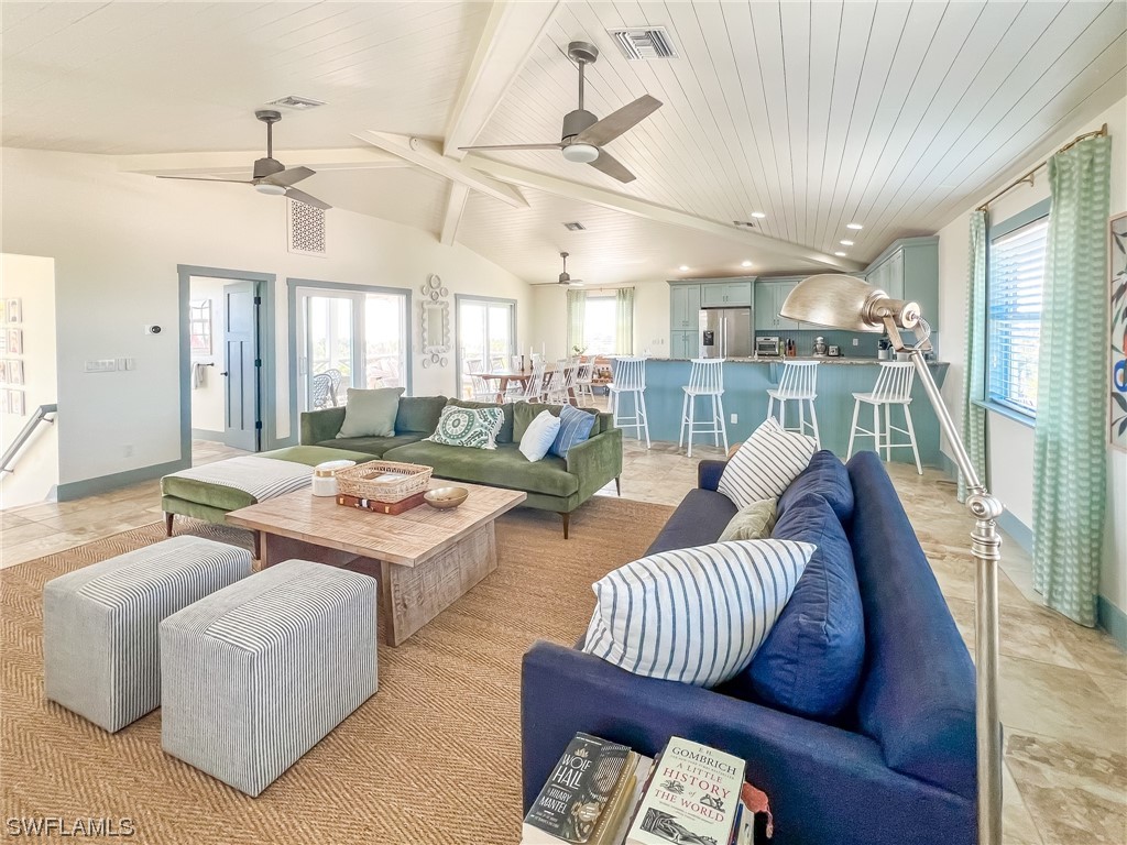 4480 Panama Shell Drive Upper Captiva, FL 33924 - Photo 36 of 50 a living room with patio furniture and a large window