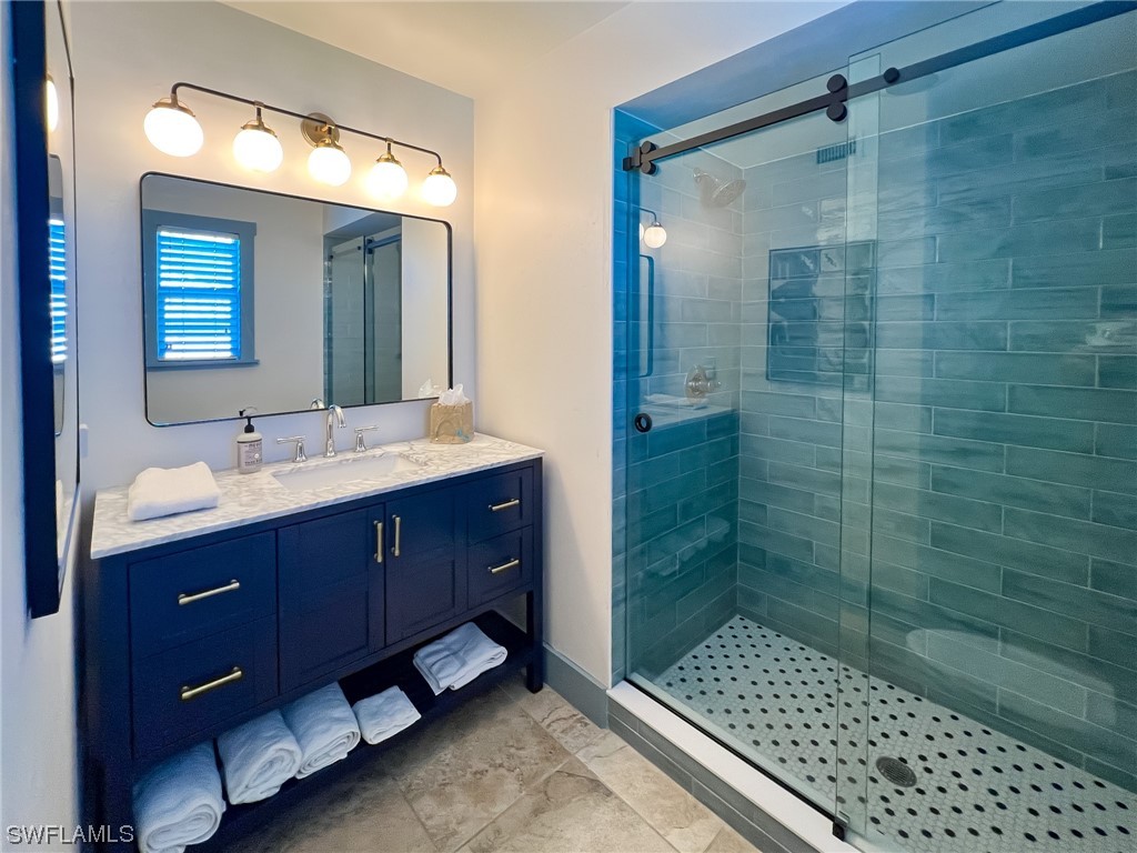 4480 Panama Shell Drive Upper Captiva, FL 33924 - Photo 46 of 50 a bathroom with a sink shower and a mirror