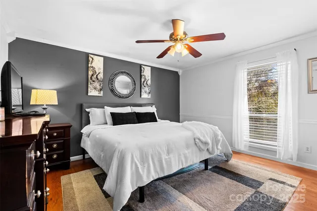 a bedroom with a bed and dresser with mirror