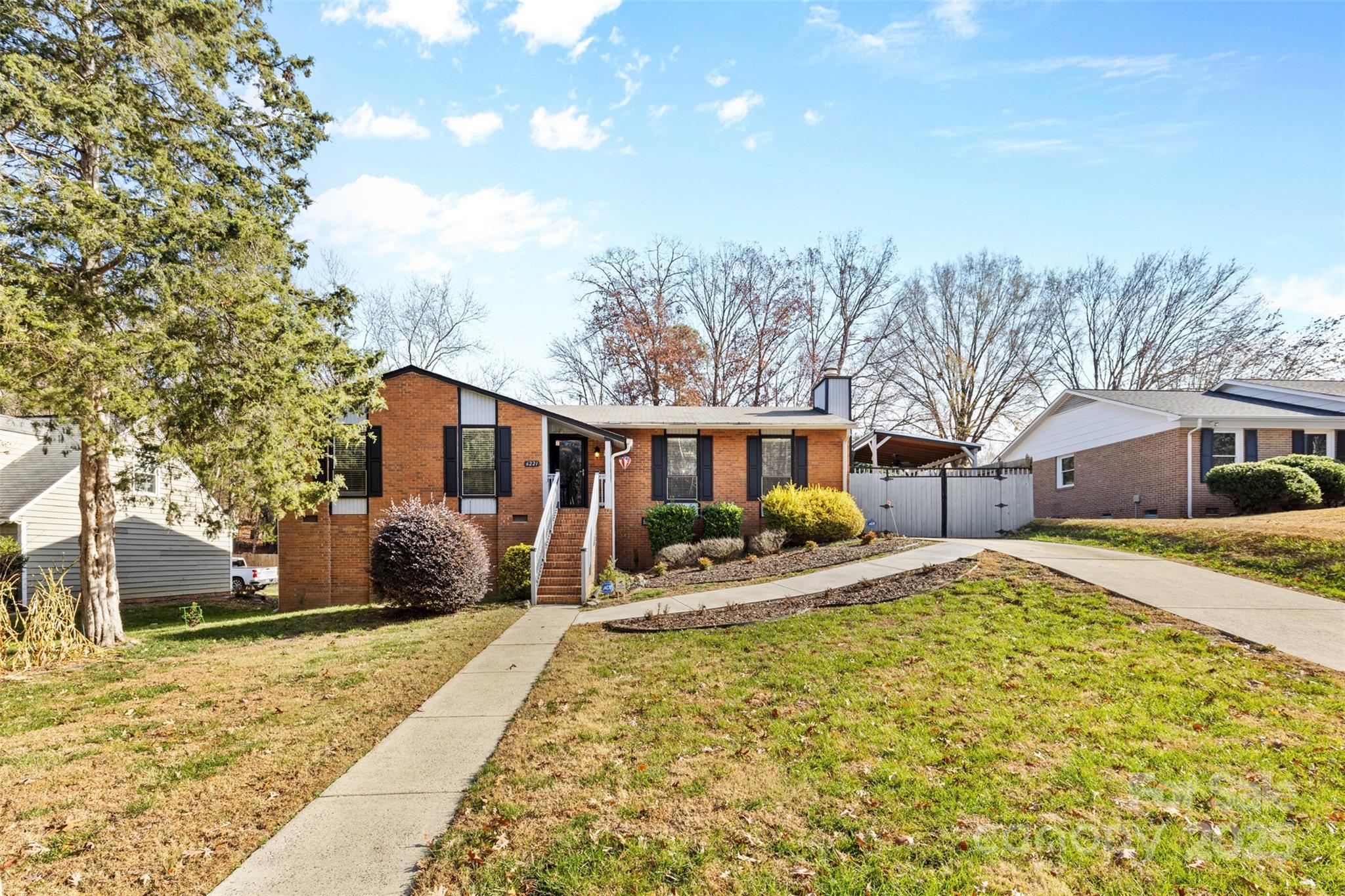 6221 Thermal Road Charlotte, NC 28211 - Photo 34 of 36 a front view of a house with a yard covered with snow and trees
