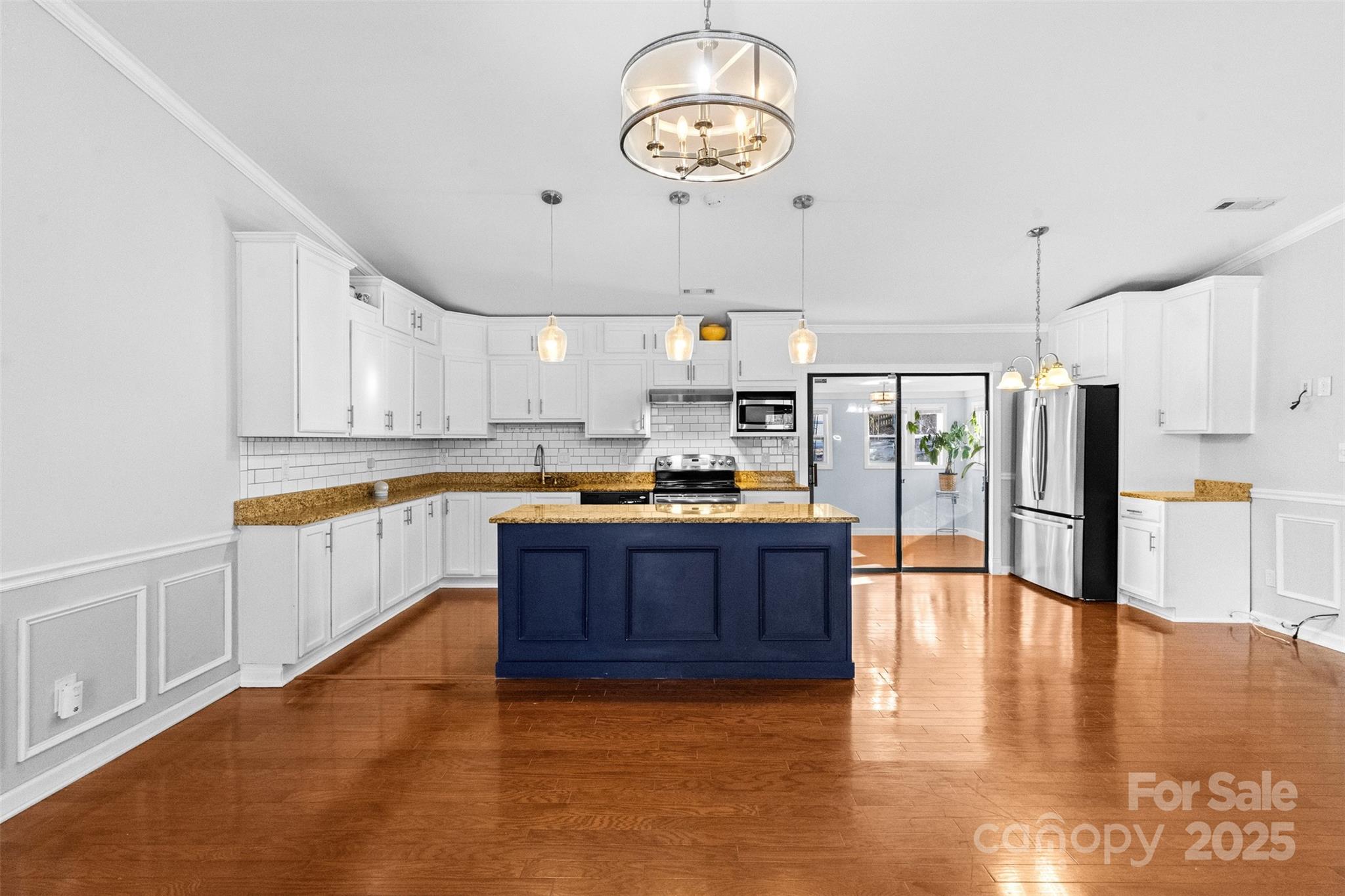 6221 Thermal Road Charlotte, NC 28211 - Photo 7 of 36 a large kitchen with stainless steel appliances granite countertop a stove a refrigerator a sink dishwasher and white cabinets with wooden floor