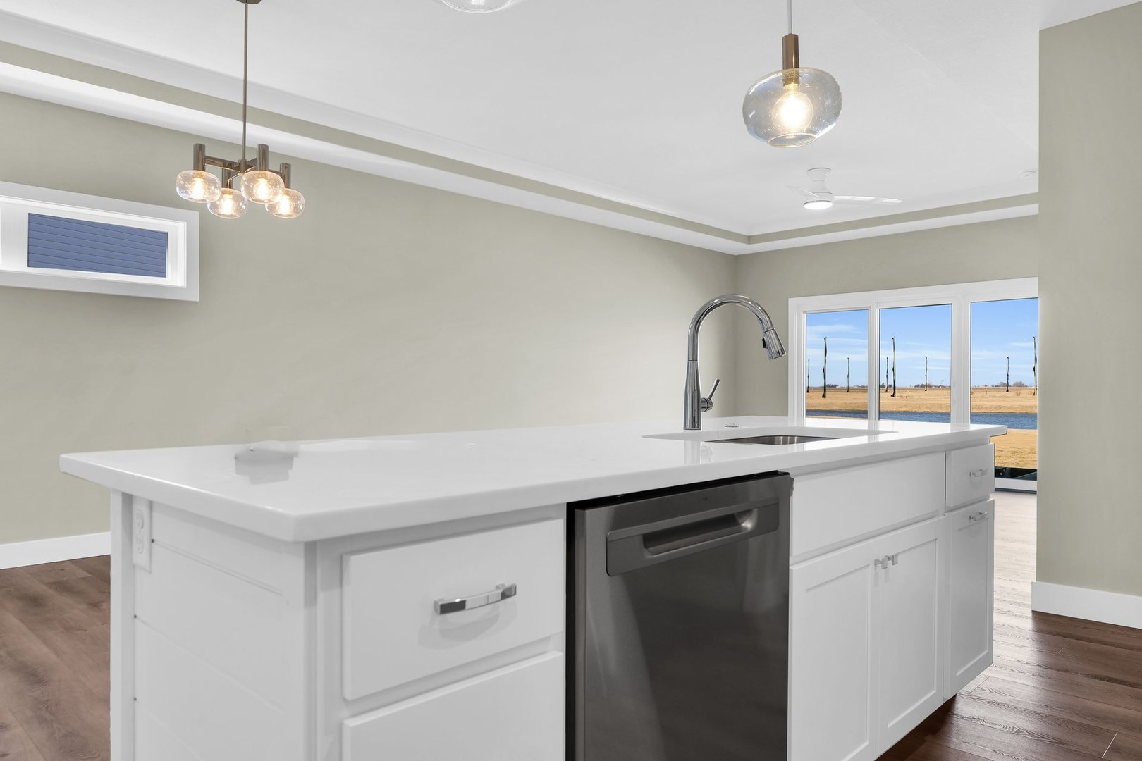 4518 Legends Drive Champaign, IL 61822 - Photo 11 of 44 a kitchen with a sink dishwasher a stove and white cabinets with wooden floor