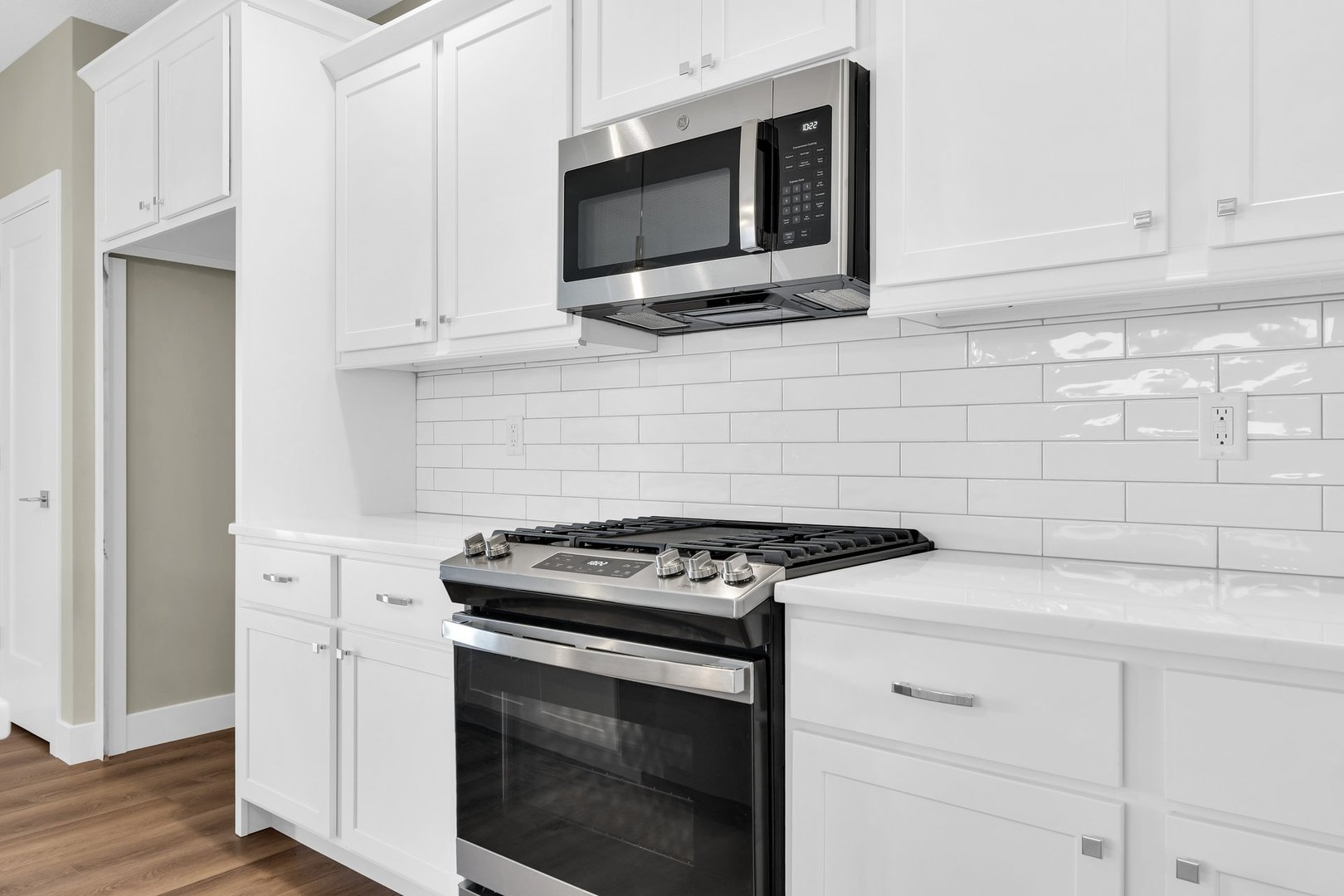 4518 Legends Drive Champaign, IL 61822 - Photo 13 of 44 a kitchen with stainless steel appliances white cabinets and a stove top oven