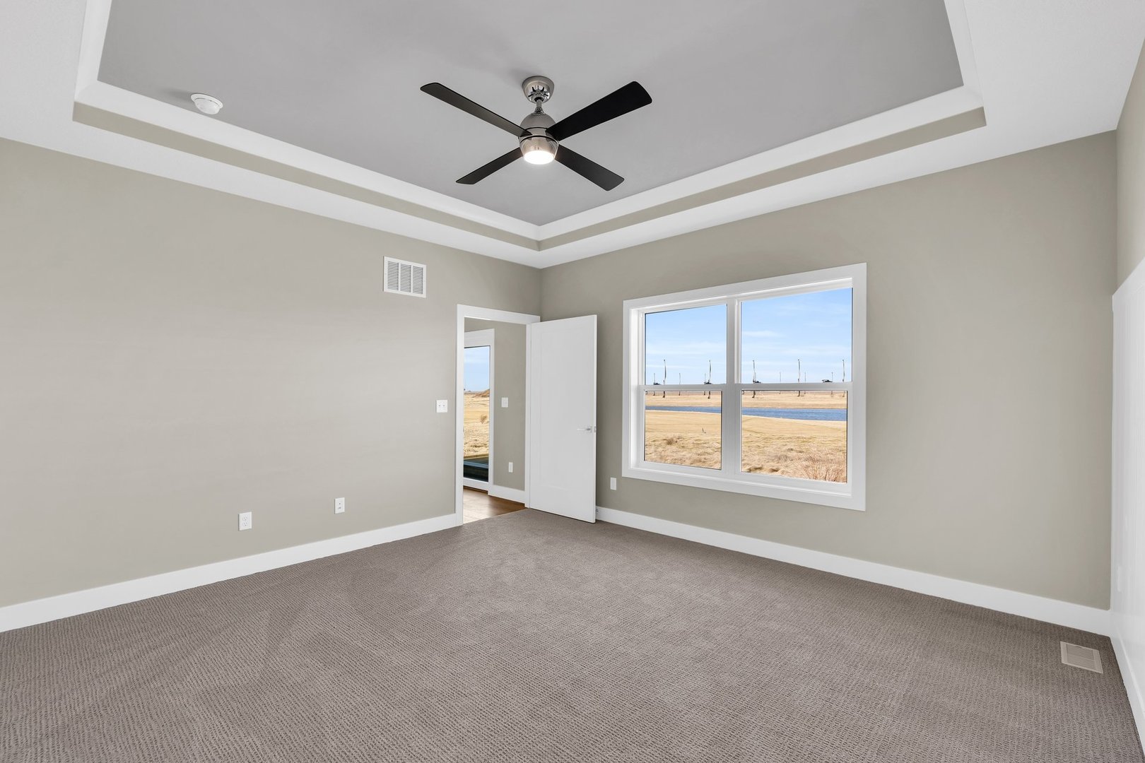 4518 Legends Drive Champaign, IL 61822 - Photo 27 of 44 an empty room with ceiling fan and windows