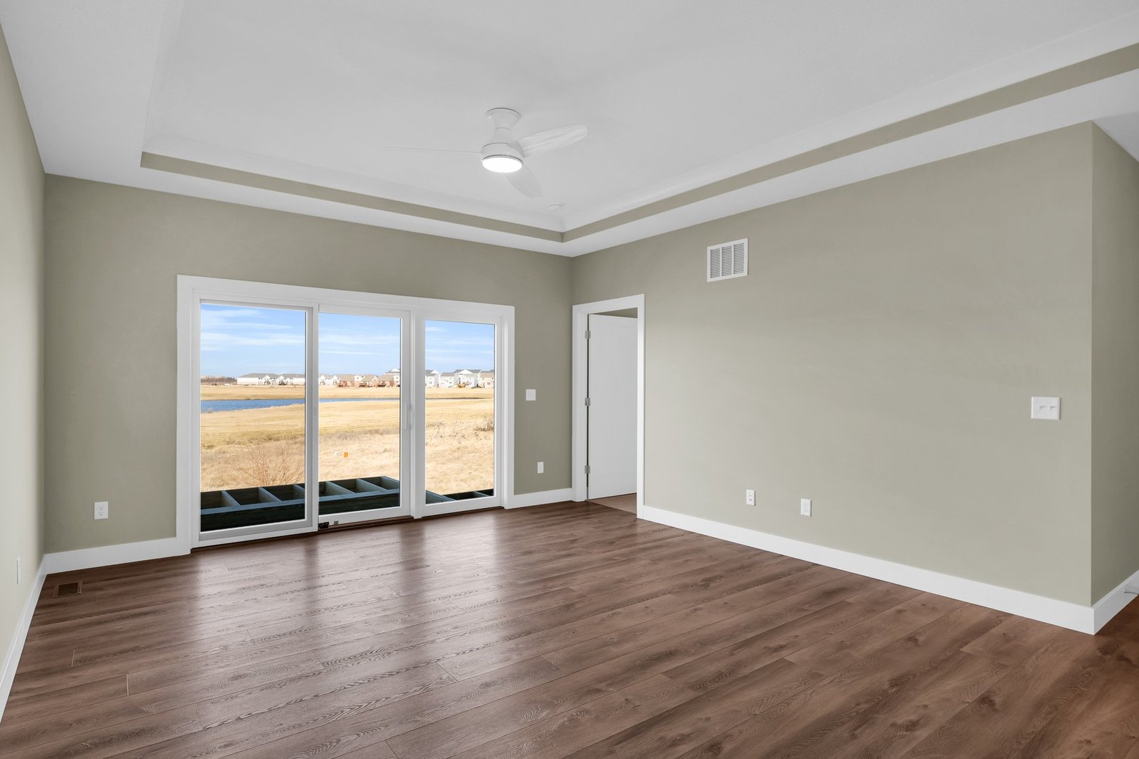 4518 Legends Drive Champaign, IL 61822 - Photo 7 of 44 a view of an empty room with wooden floor and a window
