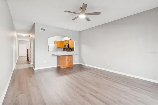 a view of staircase with white walls and railing