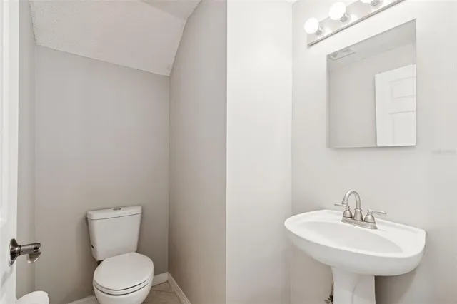 a bedroom with bed tv and window