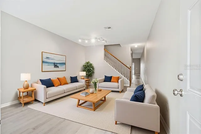 a view of an empty room with wooden floor