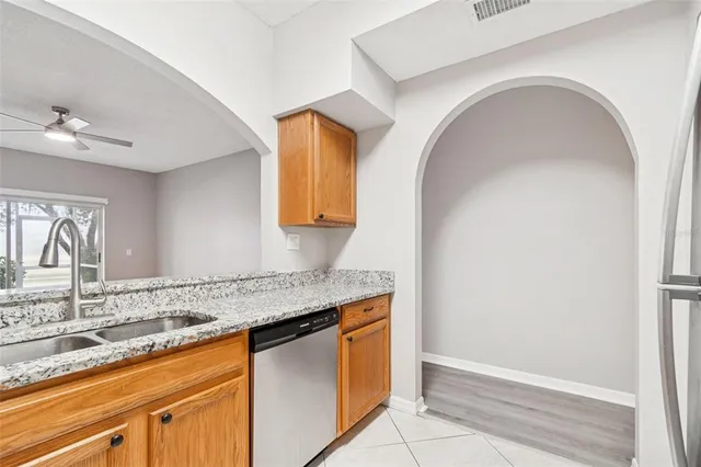 a living room with furniture a flat screen tv and kitchen view